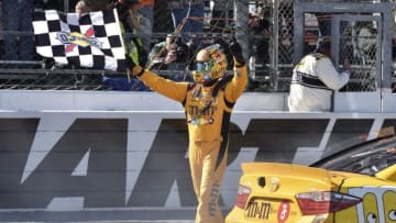 Apr 2, 2016; Martinsville, VA, USA; NASCAR Sprint Cup Series driver Kyle Busch (18) celebrates after winning the Alpha Energy Solutions 250 at Martinsville Speedway. Mandatory Credit: Michael Shroyer-USA TODAY Sports