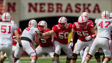 LINCOLN, NE - APRIL 15: Nebraska Cornhuskers offensive linemen John Raridon #50 and Christian Gaylord #65 are pass blocking for quarterback Tanner Lee #13 during the Spring Game at Memorial Stadium in Lincoln, Nebraska. Red 55 White 7. (Photo by John Peterson/Icon Sportswire via Getty Images)