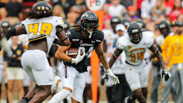 Auburn footballSep 10, 2022; Cincinnati, Ohio, USA; Cincinnati Bearcats wide receiver Nick Mardner (84) runs with the ball against Kennesaw State Owls linebacker Juandarion Silas (49) and linebacker Jalen Barnum (14) in the second half at Nippert Stadium. Mandatory Credit: Katie Stratman-USA TODAY Sports