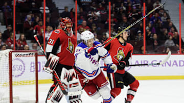 OTTAWA, ON - NOVEMBER 22: New York Rangers Center Brett Howden (21) battles for position against Ottawa Senators Defenceman Maxime Lajoie (58) in front of Ottawa Senators Goalie Anders Nilsson (31) during the third period of the NHL game between the Ottawa Senators and the New York Rangers on Nov. 22, 2019 at the Canadian Tire Centre in Ottawa, Ontario, Canada. (Photo by Steven Kingsman/Icon Sportswire via Getty Images)