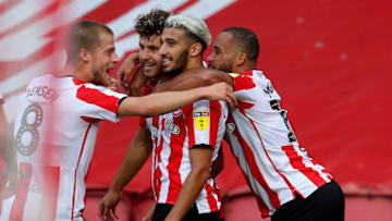 BRENTFORD, ENGLAND - JULY 29: Emiliano Marcondes #17 of Brentford celebrate with his team mates after he scores his team's second goal during the Sky Bet Championship Play Off Semi-final 2nd Leg match between Brentford and Swansea City at Griffin Park on July 29, 2020 in Brentford, England. Football Stadiums around Europe remain empty due to the Coronavirus Pandemic as Government social distancing laws prohibit fans inside venues resulting in all fixtures being played behind closed doors. (Photo by Catherine Ivill/Getty Images)