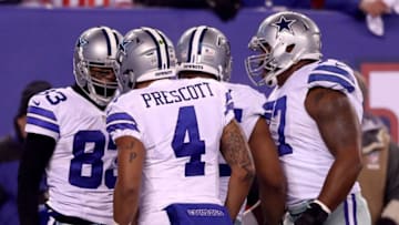 EAST RUTHERFORD, NJ - DECEMBER 11: Dak Prescott #4 of the Dallas Cowboys celebrates with Terrance Williams #83 after scoring a 31 yard touchdown against the New York Giants during the first quarter of the game at MetLife Stadium on December 11, 2016 in East Rutherford, New Jersey. (Photo by Elsa/Getty Images)