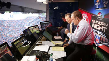 In a file photo from 2014, Al Michaels (right) and Cris Collinsworth (center) in the broadcast booth before a game on "Sunday Night Football."2018-9-1-al-michaels-collinsworth