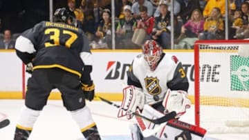 Jan 31, 2016; Nashville, TN, USA; Metropolitan Division goaltender Cory Schneider (35) of the New Jersey Devils makes a save against Atlantic Division forward Patrice Bergeron (37) of the Boston Bruins during the 2016 NHL All Star Game at Bridgestone Arena. Mandatory Credit: Aaron Doster-USA TODAY Sports