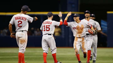 Sep 24, 2016; St. Petersburg, FL, USA; Boston Red Sox right fielder Mookie Betts (50), second baseman Dustin Pedroia (15), shortstop Xander Bogaerts (2) and teammates congratulate each other as they beat the Tampa Bay Rays at Tropicana Field. Boston Red Sox defeated the Tampa Bay Rays 6-4. Mandatory Credit: Kim Klement-USA TODAY Sports
