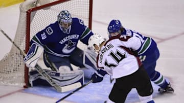 Mar 16, 2016; Vancouver, British Columbia, CAN; Colorado Avalanche forward Carl Soderberg (34) shoots the puck against Vancouver Canucks goaltender Ryan Miller (30) and defenseman Ben Hutton (27) during the second period at Rogers Arena. Mandatory Credit: Anne-Marie Sorvin-USA TODAY Sports