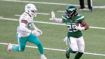 Nov 29, 2020; East Rutherford, New Jersey, USA; New York Jets running back Ty Johnson (25) carries the ball as Miami Dolphins outside linebacker Jerome Baker (55) pursues during the second half at MetLife Stadium. Mandatory Credit: Vincent Carchietta-USA TODAY Sports