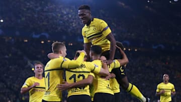 DORTMUND, GERMANY - OCTOBER 24: Raphael Guerreiro of Borussia Dortmund celebrates with teammates after scoring his team's second goal during the Group A match of the UEFA Champions League between Borussia Dortmund and Club Atletico de Madrid at Signal Iduna Park on October 24, 2018 in Dortmund, Germany. (Photo by Christof Koepsel/Bongarts/Getty Images)