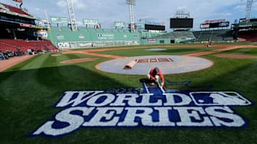 Oct 22, 2013; Boston, MA, USA; Chris Williams paints the World Series logo on the field during media day the day before game one of the 2013 World Series between the Boston Red Sox and St. Louis Cardinals at Fenway Park. Mandatory Credit: Robert Deutsch-USA TODAY Sports