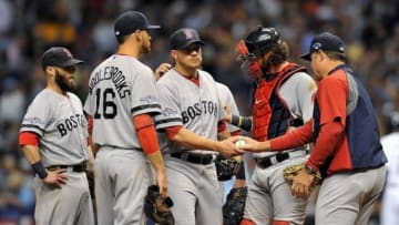 Oct 8, 2013; St. Petersburg, FL, USA; Boston Red Sox manager John Farrell (right) takes starting pitcher Jake Peavy (center) out of the game during the sixth inning against the Tampa Bay Rays in game four of the American League divisional series at Tropicana Field. Mandatory Credit: Steve Mitchell-USA TODAY Sports