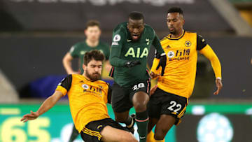 WOLVERHAMPTON, ENGLAND - DECEMBER 27: Tanguy NDombele of Tottenham Hotspur is challenged by Ruben Neves and Nelson Semedo of Wolverhampton Wanderers during the Premier League match. (Photo by Carl Recine - Pool/Getty Images)