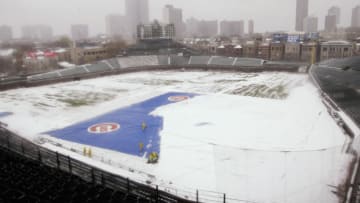 CHICAGO, IL - APRIL 7: Workmen from the Wrigley Field grounds crew shovel snow from the infield of the park in Chicago, Illinois April 7, 2003. The Chicago Cubs were to play their home opener against the Montreal Expos today but the game was cancelled due to the snow. (Photo by Scott Olson/Getty Images)