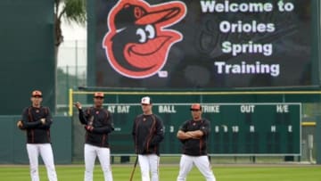 Mar 7, 2015; Sarasota, FL, USA; Baltimore Orioles third baseman Ryan Flaherty (3), Baltimore Orioles second baseman Jonathan Schoop (6), third base coach Bobby Dickerson (11) and Baltimore Orioles left fielder David Lough (9) work out before a spring training baseball game against the Boston Red Sox at Ed Smith Stadium. Mandatory Credit: Kim Klement-USA TODAY Sports