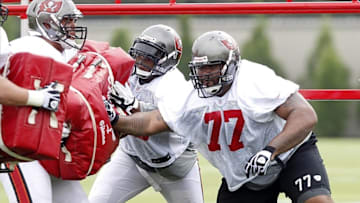 Jul 25, 2013; Tampa, FL, USA; Tampa Bay Buccaneers guard Carl Nicks (77) and center Jeremy Zuttah (76) practice during training camp at One Buccaneer Place. Mandatory Credit: Kim Klement-USA TODAY Sports