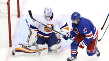 TORONTO, ONTARIO - JULY 29: Thomas Greiss #1 of the New York Islanders stops a shot as Jesper Fast #17 of the New York Rangers chases the rebound in the third period during an exhibition game prior to the 2020 NHL Stanley Cup Playoffs at Scotiabank Arena on July 29, 2020 in Toronto, Ontario. (Photo by Andre Ringuette/Freestyle Photo/Getty Images)