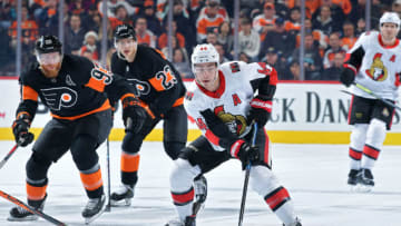 PHILADELPHIA, PA - DECEMBER 07: Jean-Gabriel Pageau #44 of the Ottawa Senators skates into the offensive zone ahead of Jakub Voracek #93 and Oskar Lindblom #23 of the Philadelphia Flyers in the first period at Wells Fargo Center on December 7, 2019 in Philadelphia, Pennsylvania. (Photo by Drew Hallowell/Getty Images)