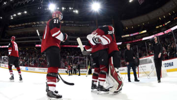 GLENDALE, ARIZONA - NOVEMBER 18: Goalie Antti Raanta #32 of the Arizona Coyotes is congratulated by teammates Jason Demers #55 and Derek Stepan #21 following a 3-0 shutout victory against the Los Angeles Kings at Gila River Arena on November 18, 2019 in Glendale, Arizona. (Photo by Norm Hall/NHLI via Getty Images)