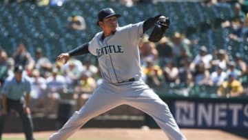 September 3, 2014; Oakland, CA, USA; Seattle Mariners starting pitcher Felix Hernandez (34) delivers a pitch against the Oakland Athletics during the first inning at O.co Coliseum. Mandatory Credit: Kyle Terada-USA TODAY Sports
