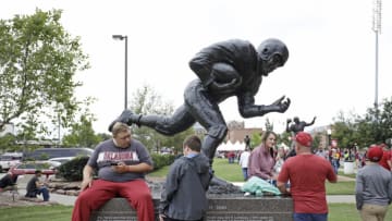 NORMAN, OK - SEPTEMBER 22: Oklahoma Sooners fans wait on the statue of Heisman Trophy winner Billy Vessels before the game against the Army Black Knights at Gaylord Family Oklahoma Memorial Stadium on September 22, 2018 in Norman, Oklahoma. (Photo by Brett Deering/Getty Images)
