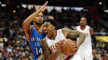 Nov 30, 2015; Atlanta, GA, USA; Atlanta Hawks guard Jeff Teague (0) works against the defense of Oklahoma City Thunder guard D.J. Augustin (14) during the second half at Philips Arena. The Hawks defeated the Thunder 106-100. Mandatory Credit: Dale Zanine-USA TODAY Sports