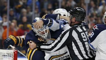 Jan 7, 2017; Buffalo, NY, USA; NHL linesman David Brisebois (96) breaks up a fight between Buffalo Sabres goalie Robin Lehner (40) and Winnipeg Jets defenseman Dustin Byfuglien (33) during the third period at KeyBank Center. Buffalo beats Winnipeg 4 to 3. Mandatory Credit: Timothy T. Ludwig-USA TODAY Sports