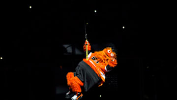 PHILADELPHIA, PA - OCTOBER 09: The Flyers mascot "Gritty" makes his entrance to "Wrecking Ball" lowered from the ceiling before the NHL game between the San Jose Sharks and the Philadelphia Flyers on October 09, 2018 at the Wells Fargo Center in Philadelphia PA. (Photo by Gavin Baker/Icon Sportswire via Getty Images)