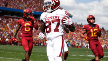 AMES, IA - SEPTEMBER 15: Wide receiver Myles Tease #87 of the Oklahoma Sooners scores a touchdown as defensive back De'Monte Ruth #6, and defensive back Greg Eisworth #12 of the Iowa State Cyclones both defend on the play in the first half of play at Jack Trice Stadium on September 15, 2018 in Ames, Iowa. .(Photo by David Purdy/Getty Images)