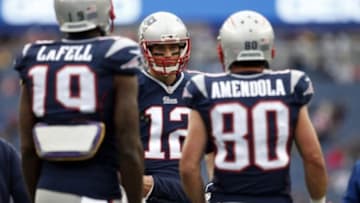 Dec 28, 2014; Foxborough, MA, USA; New England Patriots quarterback Tom Brady (12) talks to wide receiver Brandon LaFell (19) and wide receiver Danny Amendola (80) before the start of the game against the Buffalo Bills at Gillette Stadium. Mandatory Credit: David Butler II-USA TODAY Sports