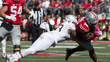 Oct 10, 2015; Columbus, OH, USA; Maryland Terrapins linebacker Jermaine Carter Jr. (23) tackles Ohio State Buckeyes running back Ezekiel Elliott (15) at Ohio Stadium. Mandatory Credit: Greg Bartram-USA TODAY Sports