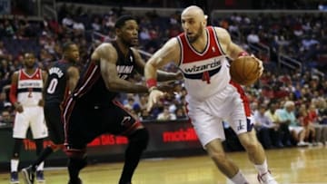 Apr 14, 2014; Washington, DC, USA; Washington Wizards center Marcin Gortat (4) dribbles the ball as Miami Heat forward Udonis Haslem (40) defends in the first quarter at Verizon Center. Mandatory Credit: Geoff Burke-USA TODAY Sports