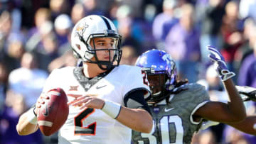 FORT WORTH, TX - NOVEMBER 19: Mason Rudolph #2 of the Oklahoma State Cowboys looks for an open receiver against Denzel Johnson #30 of the TCU Horned Frogs in the second half at Amon G. Carter Stadium on November 19, 2016 in Fort Worth, Texas. (Photo by Tom Pennington/Getty Images)