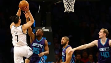 Dec 26, 2016; Brooklyn, NY, USA; Brooklyn Nets guard Jeremy Lin (7) shoots the ball as Charlotte Hornets guard Kemba Walker (15) defends during the first half at Barclays Center. Mandatory Credit: Andy Marlin-USA TODAY Sports