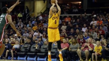 Oct 14, 2014; Cleveland, OH, USA; Cleveland Cavaliers forward Kevin Love (0) shoots a three-point basket in the first quarter against the Milwaukee Bucks at Quicken Loans Arena. Mandatory Credit: David Richard-USA TODAY Sports