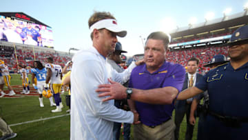 Mississippi Rebels head coach Lane Kiffin (left) and LSU Tigers head coach Ed Orgeron (right) shake hands after a game at Vaught-Hemingway Stadium. Mandatory Credit: Petre Thomas-USA TODAY Sports