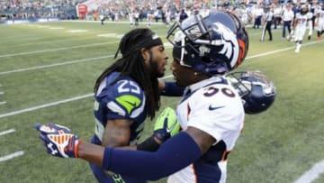 Sep 21, 2014; Seattle, WA, USA; Seattle Seahawks cornerback Richard Sherman (25) and Denver Broncos cornerback Kayvon Webster (36) greet after the game at CenturyLink Field. Seattle defeated Denver 26-20. Mandatory Credit: Steven Bisig-USA TODAY Sports