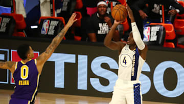 Aug 8, 2020; Lake Buena Vista, Florida, USA; Indiana Pacers guard Victor Oladipo (4) shoots the ball against Los Angeles Lakers forward Kyle Kuzma (0) during the second quarter in a NBA basketball game at The Field House. Mandatory Credit: Kim Klement-USA TODAY Sports