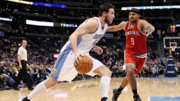 Mar 3, 2015; Denver, CO, USA; Denver Nuggets forward Danilo Gallinari (8) dribbles the ball against Milwaukee Bucks guard Jared Dudley (9) in the third quarter at Pepsi Center. The Nuggets defeated the Bucks 106-95. Mandatory Credit: Isaiah J. Downing-USA TODAY Sports