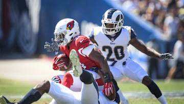 LOS ANGELES, CA - SEPTEMBER 16: Running back David Johnson #31 of the Arizona Cardinals is tackled by linebacker Cory Littleton #58 and defensive back Lamarcus Joyner #20 of the Los Angeles Rams during the second quarter at Los Angeles Memorial Coliseum on September 16, 2018 in Los Angeles, California. (Photo by Harry How/Getty Images)
