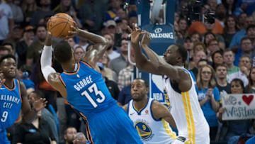 OKLAHOMA CITY, OK - NOVEMBER 22: Paul George #13 of the Oklahoma City Thunder shoots over Nick Young #6 of the Golden State Warriors and Draymond Green #23 of the Golden State Warriors during the second half of a NBA game at the Chesapeake Energy Arena on November 22, 2017 in Oklahoma City, Oklahoma. NOTE TO USER: User expressly acknowledges and agrees that, by downloading and or using this photograph, User is consenting to the terms and conditions of the Getty Images License Agreement. (Photo by J Pat Carter/Getty Images)
