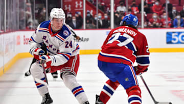 MONTREAL, QC - OCTOBER 16: Kaapo Kakko #24 of the New York Rangers skates the puck against Alexander Romanov #27 of the Montreal Canadiens during the first period at Centre Bell on October 16, 2021 in Montreal, Canada. The New York Rangers defeated the Montreal Canadiens 3-1. (Photo by Minas Panagiotakis/Getty Images)