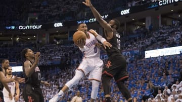 OKLAHOMA CITY, OK - APRIL 21: Russell Westbrook #0 of the Oklahoma City Thunder drives around James Harden #13 of the Houston Rockets for two points during the second half of Game Three in the 2017 NBA Playoffs Western Conference Quarterfinals on April 21, 2017 in Oklahoma City, Oklahoma. Oklahoma City defeated Houston 115-113 NOTE TO USER: User expressly acknowledges and agrees that, by downloading and or using this photograph, User is consenting to the terms and conditions of the Getty Images License Agreement. (Photo by J Pat Carter/Getty Images)