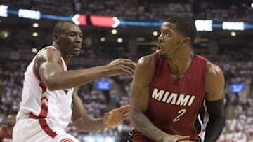 May 15, 2016; Toronto, Ontario, CAN; Miami Heat forward Joe Johnson (2) handles the ball as Toronto Raptors center Bismack Biyombo (8) tries to defend during the second quarter in game seven of the second round of the NBA Playoffs at Air Canada Centre. Mandatory Credit: Nick Turchiaro-USA TODAY Sports