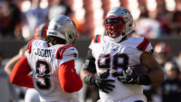 Oct 16, 2022; Cleveland, Ohio, USA; New England Patriots defensive tackle Carl Davis Jr. (98) celebrates his fumble recovery with linebacker Matthew Judon (9) against the Cleveland Browns during the fourth quarter at FirstEnergy Stadium. Mandatory Credit: Scott Galvin-USA TODAY Sports