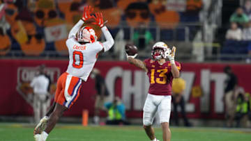 Dec 29, 2021; Orlando, Florida, USA; Clemson Tigers wide receiver Brannon Spector (13) passes the ball under pressure from Clemson Tigers linebacker Barrett Carter (0) during the second half of the 2021 Cheez-It Bowl at Camping World Stadium. Mandatory Credit: Jasen Vinlove-USA TODAY Sports