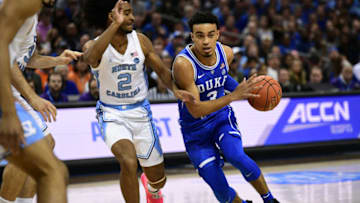 CHARLOTTE, NC - MARCH 15: Duke Blue Devils guard Tre Jones (3) drives around North Carolina Tar Heels guard Coby White (2) during the ACC basketball tournament between the Duke Blue Devils and the North Carolina Tar Heels on March 15, 2019, at the Spectrum Center in Charlotte, NC. (Photo by William Howard/Icon Sportswire via Getty Images)