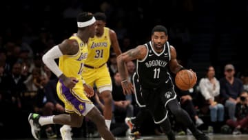 Jan 30, 2023; Brooklyn, New York, USA; Brooklyn Nets guard Kyrie Irving (11) brings the ball up court against Los Angeles Lakers guard Dennis Schroder (17) during the first quarter at Barclays Center. Mandatory Credit: Brad Penner-USA TODAY Sports