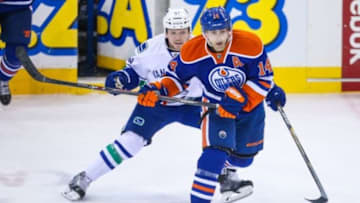 Nov 1, 2014; Edmonton, Alberta, CAN; Edmonton Oilers right wing Jordan Eberle (14) and Vancouver Canucks right wing Derek Dorsett (51) during the third period at Rexall Place. Vancouver Canucks won 3-2. Mandatory Credit: Sergei Belski-USA TODAY Sports