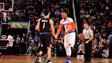 PHOENIX, AZ - DECEMBER 13: Devin Booker #1 of the Phoenix Suns and Carmelo Anthony #7 of the New York Knicks shake hands before a game on December 13, 2016 at Talking Stick Resort Arena in Phoenix, Arizona. NOTE TO USER: User expressly acknowledges and agrees that, by downloading and/or using this photograph, user is consenting to the terms and conditions of the Getty Images License Agreement. Mandatory Copyright Notice: Copyright 2016 NBAE (Photo by Barry Gossage/NBAE via Getty Images)