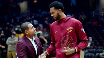 Dec 31, 2021; Cleveland, Ohio, USA; Cleveland Cavaliers general manager Koby Altman (left) congratulates center Evan Mobley (4) after awarding Mobley a plaque for wining the NBA Rookie of the Month Award for October/November before the game against the Atlanta Hawks at Rocket Mortgage FieldHouse. Mandatory Credit: Ken Blaze-USA TODAY Sports