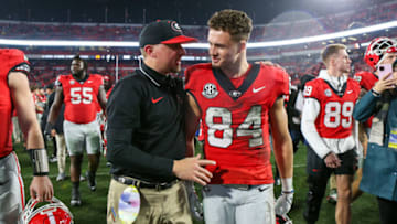Nov 11, 2023; Athens, Georgia, USA; Georgia Bulldogs tight end coach Todd Hartley talks to wide receiver Ladd McConkey (84) after a victory against the Mississippi Rebels at Sanford Stadium. Mandatory Credit: Brett Davis-USA TODAY Sports